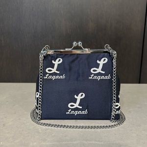 Handmade bag from jacquard fabric with woven white logo.
